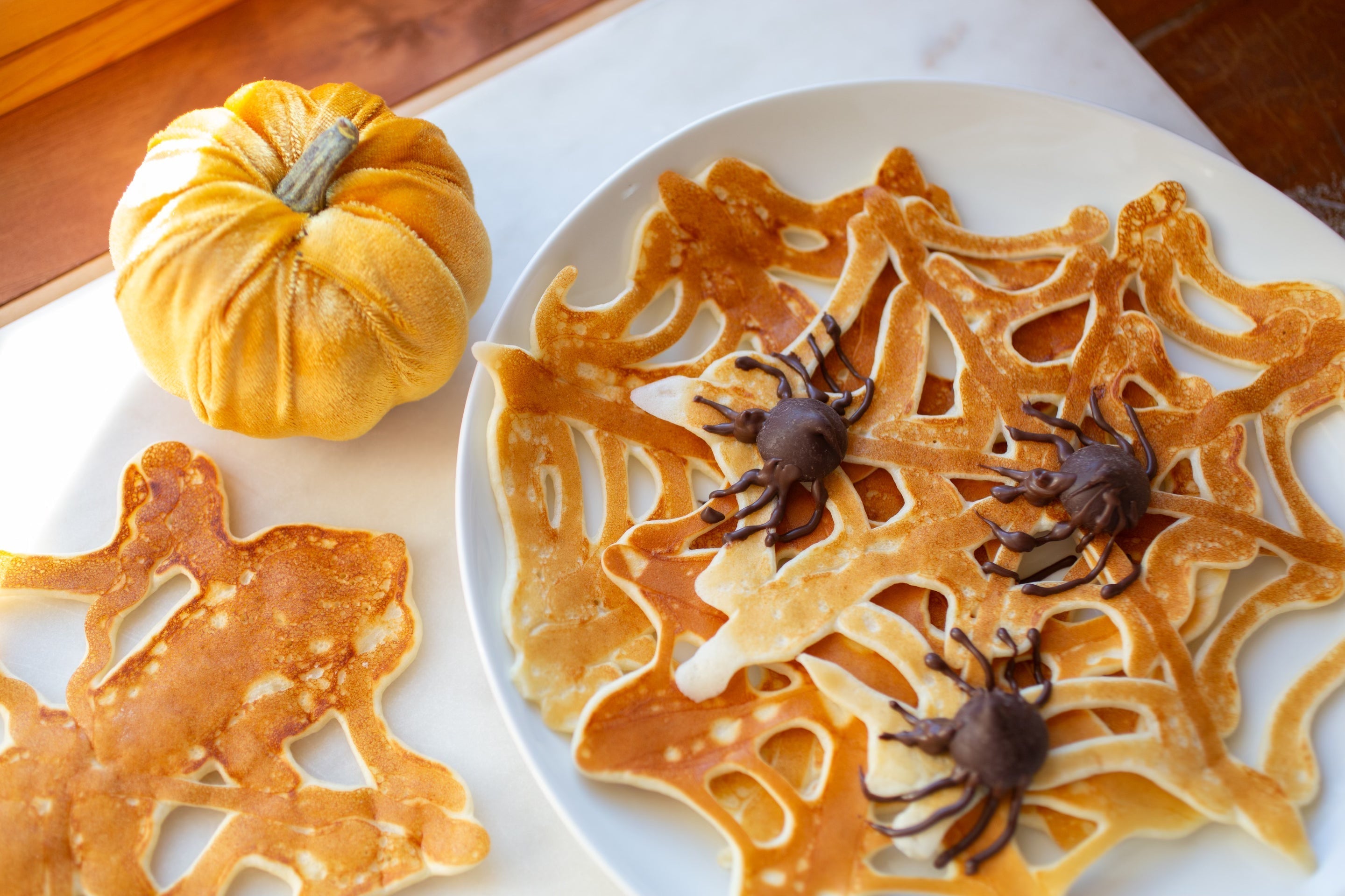Halloween spiderweb pancakes decorated with chocolate