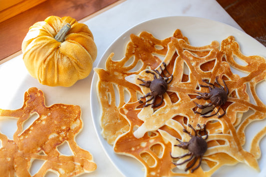 Halloween spiderweb pancakes decorated with chocolate