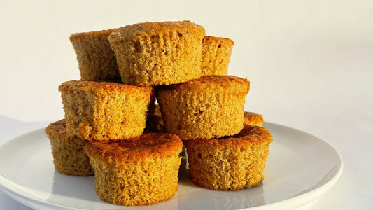 Pumpkin Harvest Heavenly Waffles Muffins stacked on a plate, golden and fluffy with a warm fall glow — made with Heavenly Waffles protein mix.